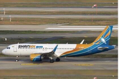 Shankh Air aircraft on the tarmac, with a tail painted yellow-to-blue