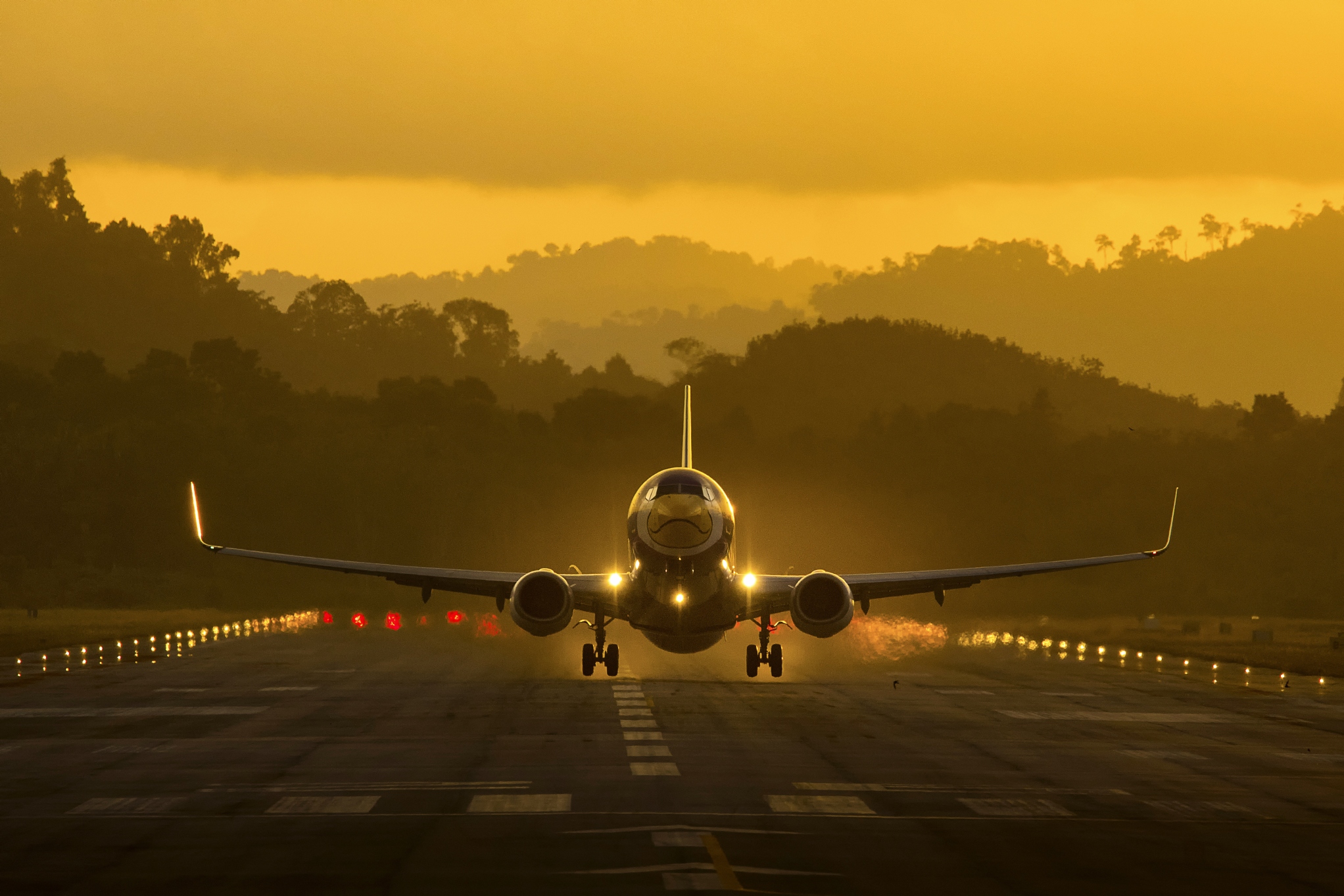 Plane taxiing on runway.