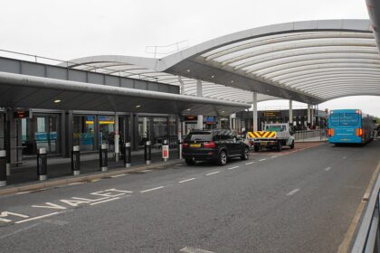 Car and truck parked in drop-off area at Gatwick airport.