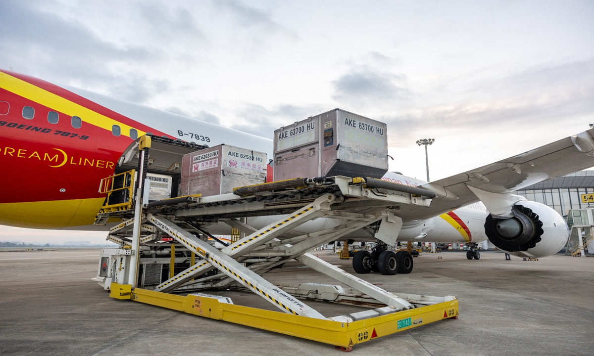 Clothing cargo from Milan, Italy, loaded onto a Hainan Airlines flight to Hong Kong after air-to-air waybill transfer.