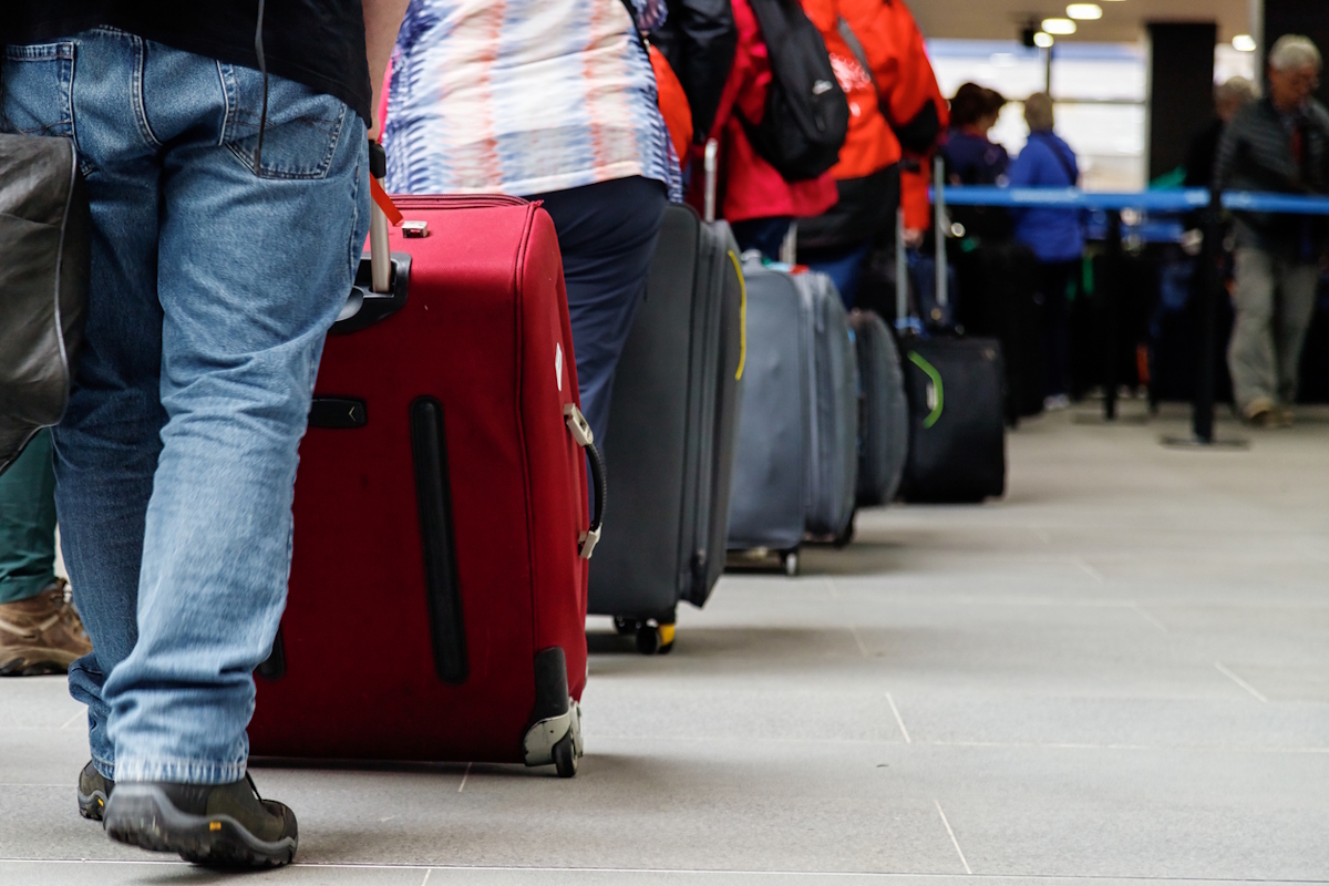 A line of people queuing for the boarding gate.