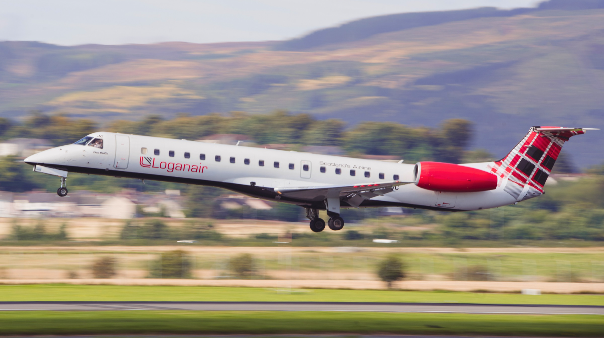 Loganair aircraft takes off from an airport