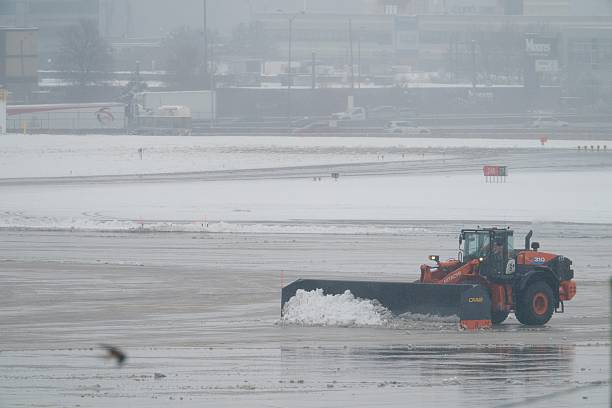 A tractor plows snow at Toronto Pearson International Airport, in Mississauga