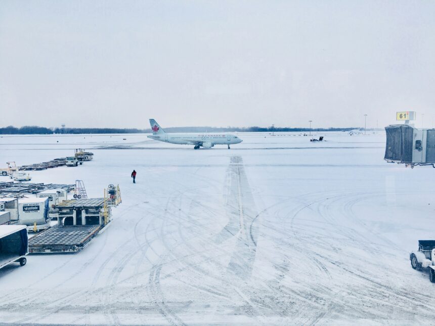 Airplane in snow covered runway.