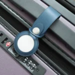 A picture of Apple's AirTag on a bag's handle bar.