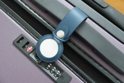 A picture of Apple's AirTag on a bag's handle bar.