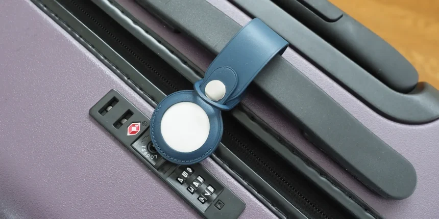 A picture of Apple's AirTag on a bag's handle bar.