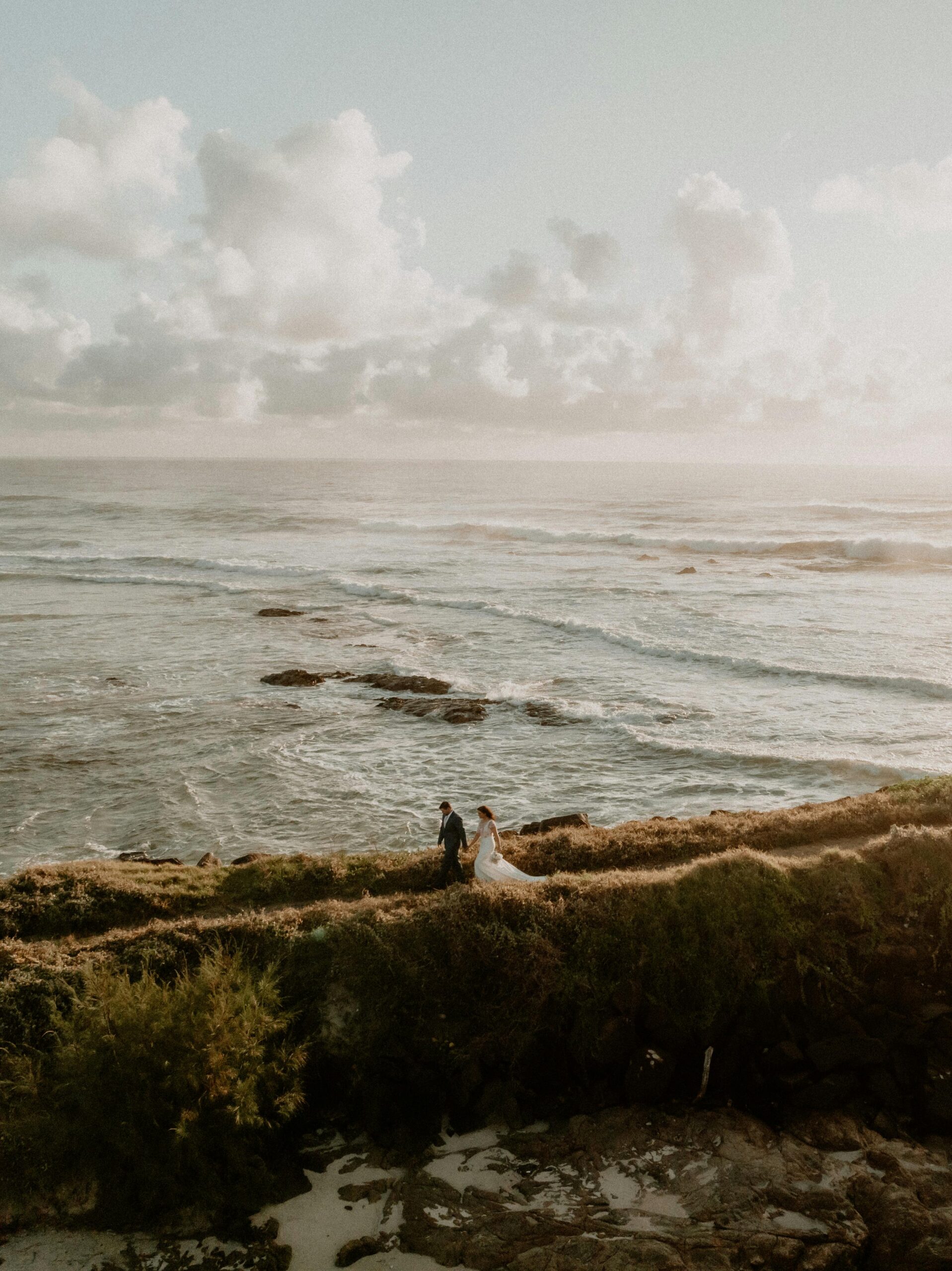 Newlywed Walking by Sea