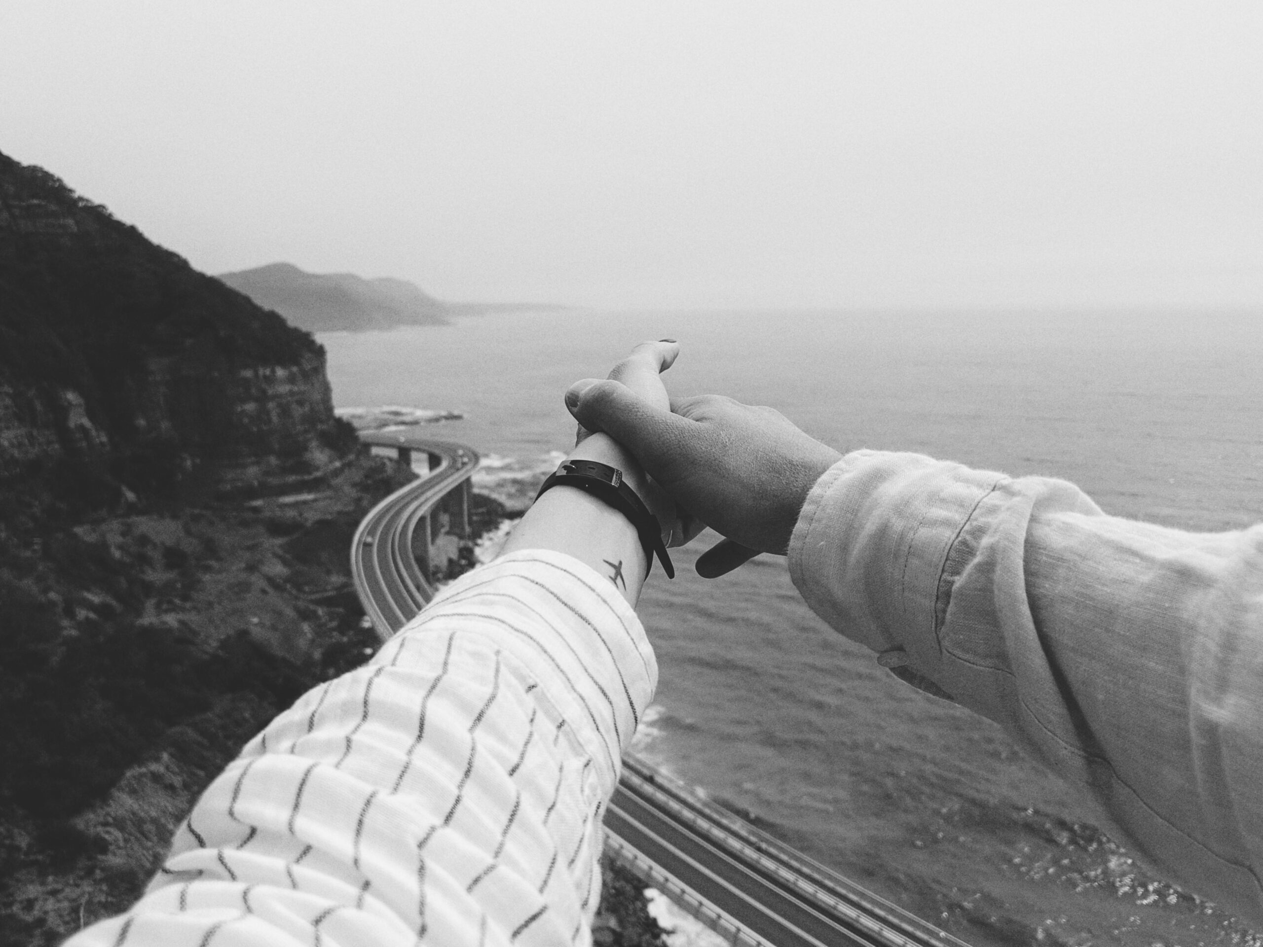 Grayscale Photo of People Holding hands 