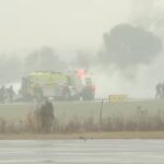 This screengrab made from video provided by WSOC shows firefighting crews responding to a reported plane crash at a regional airport in Statesville, North Carolina. © Associated Press