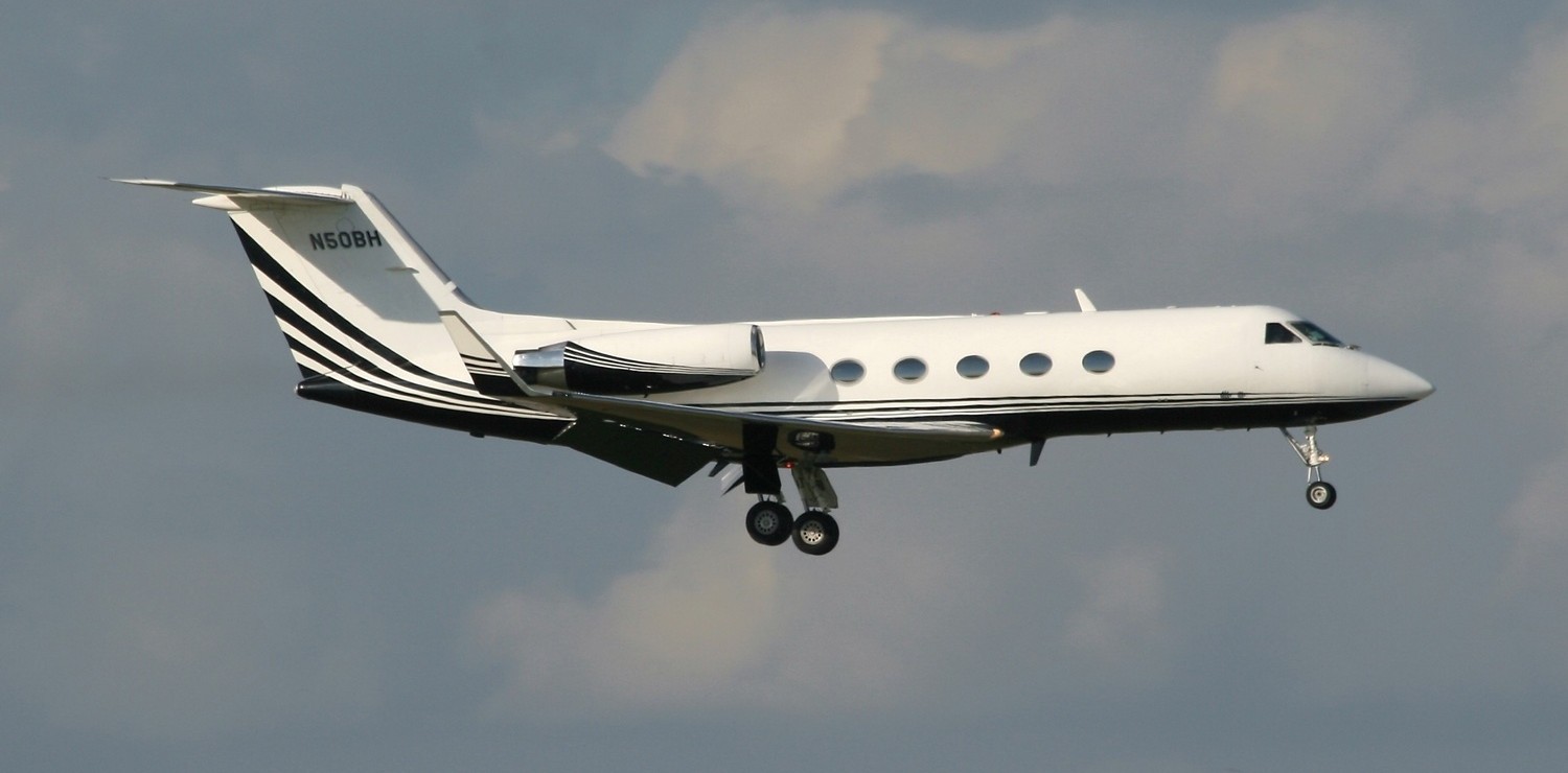 White Gulfstream N50BH aircraft flying through the clouds.