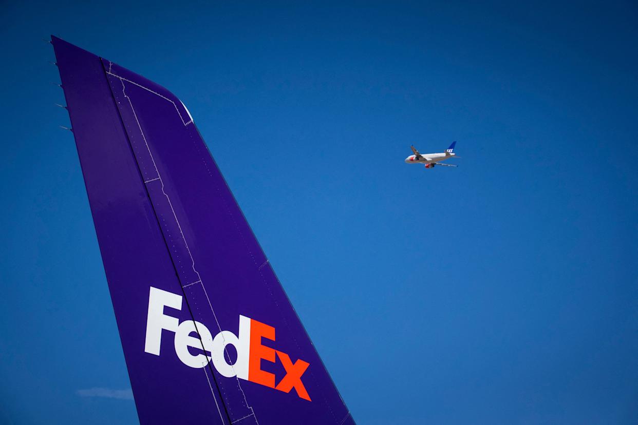 A Scandanavian Airline aircraft flying past a FedEx MD-11.