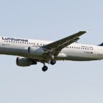 A Lufthansa Airbus A320 aircraft flying over the ground