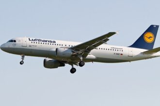 A Lufthansa Airbus A320 aircraft flying over the ground