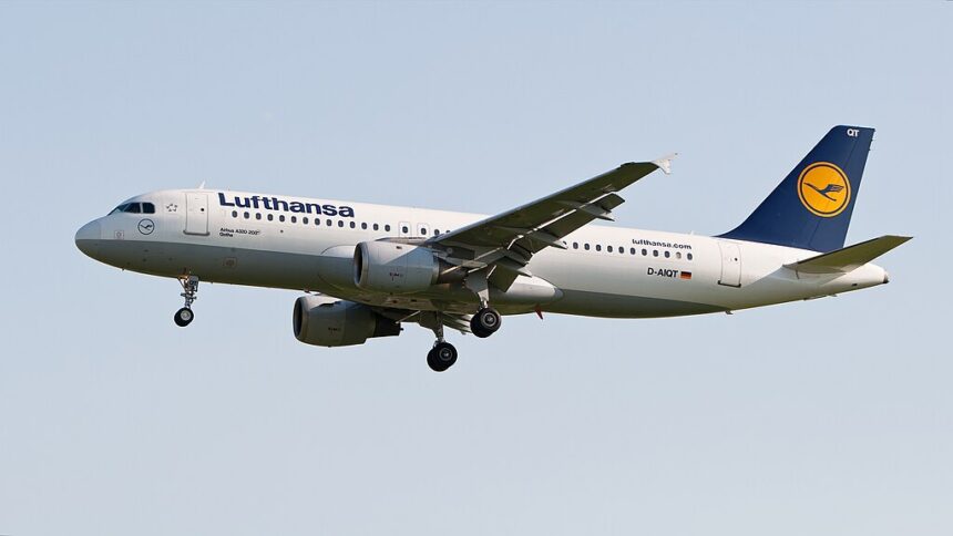 A Lufthansa Airbus A320 aircraft flying over the ground