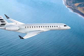 Bombardier Global 8000 ultra-long-range business jet flying over coastline, fastest business jet since Concorde