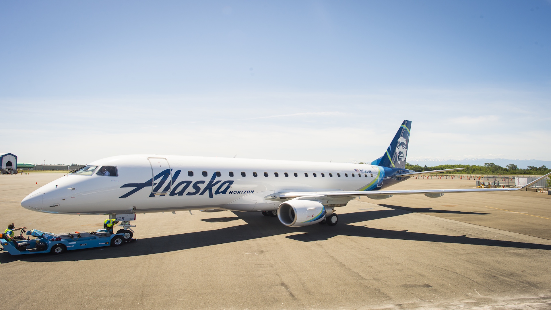 An Alaska Airlines Embraer E175 regional jet parked on a runway. They were the first of Alaska's fleet to receive Starlink.