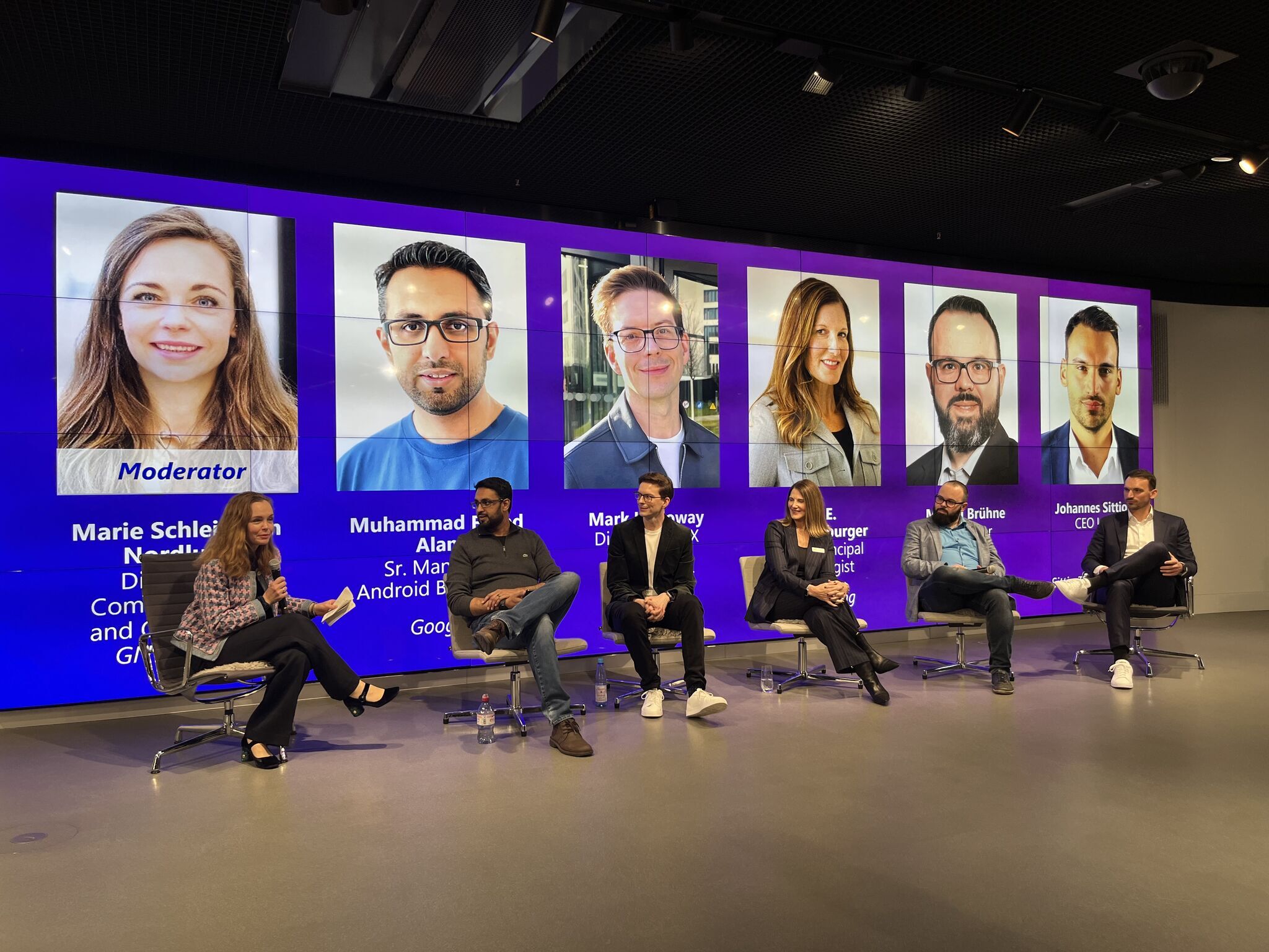 Industry experts speak on a panel at the Frankfurt Airport Auracast launch event.