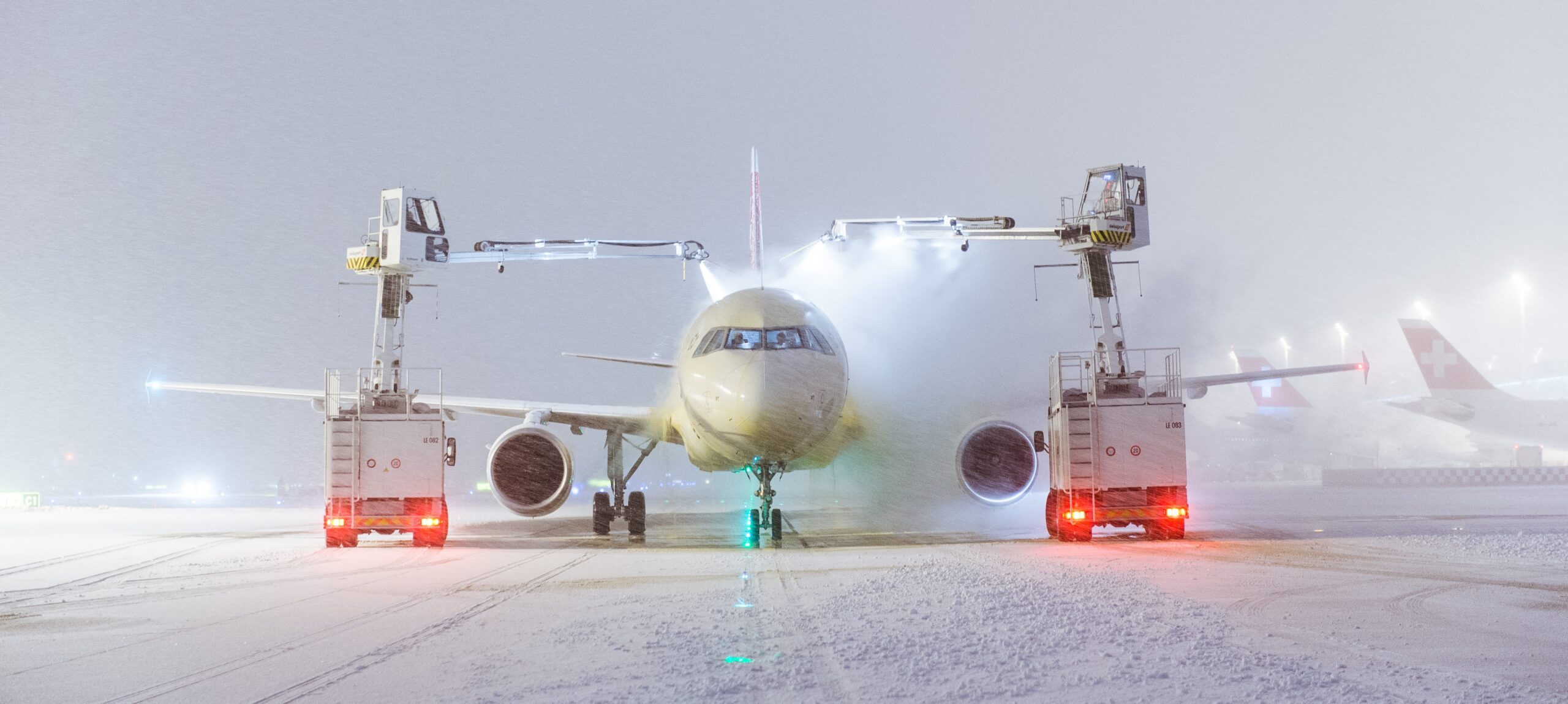 Aircraft being de-iced in the snow.