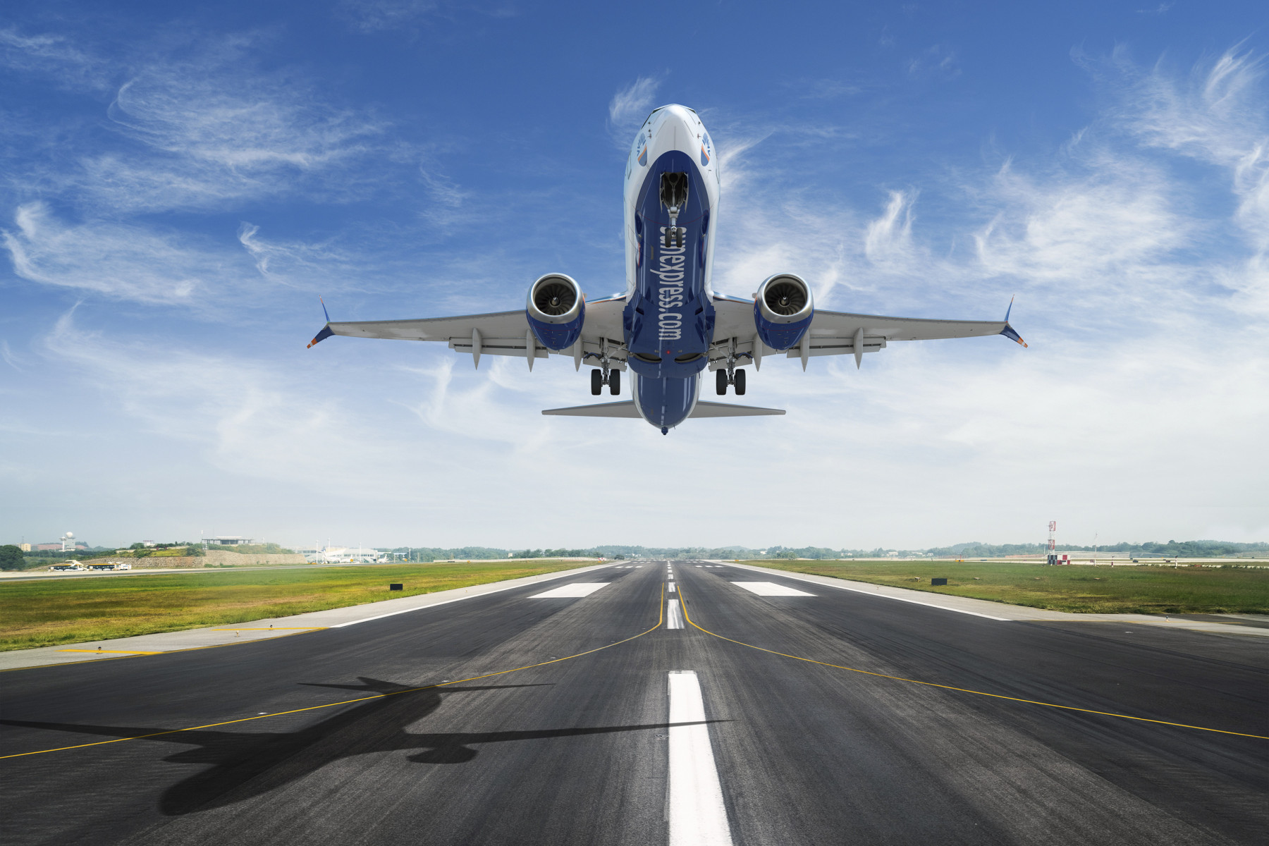SunExpress aircraft taking off on a runway.