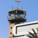 A tower overlooking the sign for Sana'a Internationlal Airport (SAH)