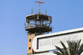 A tower overlooking the sign for Sana'a Internationlal Airport (SAH)