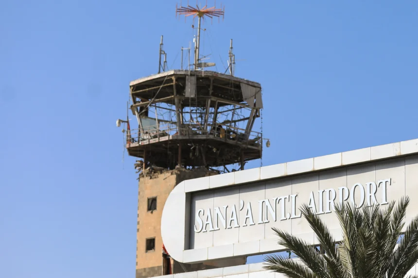 A tower overlooking the sign for Sana'a Internationlal Airport (SAH)