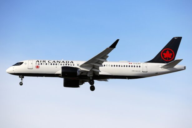 A black and white Air Canada plane with maple leaf motif on its tail engages its landing gear in the air.
