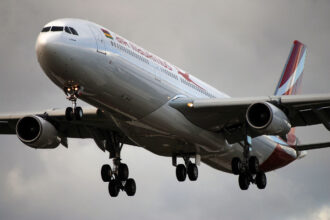 Air Mauritius aircraft flying in the cloudy sky.