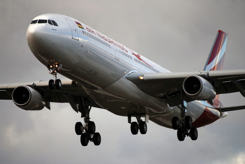 Air Mauritius aircraft flying in the cloudy sky.