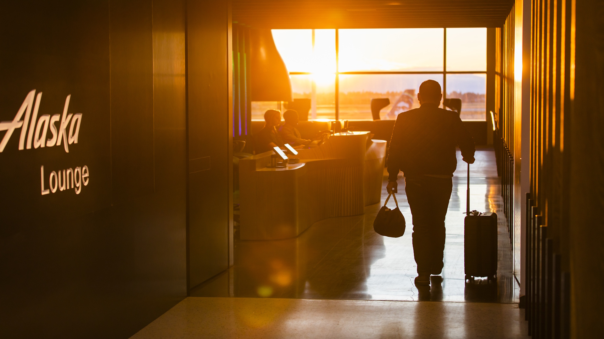 A passenger entering an Alaska Airlines airport lounge.