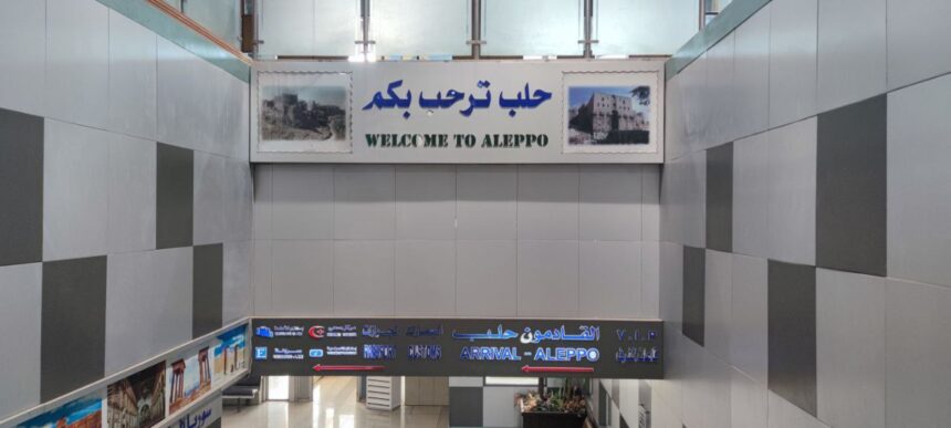 Arrivals area at Aleppo Airport, with signage written in English and Arabic.