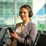 Woman listening to Auracast bluetooth announcments