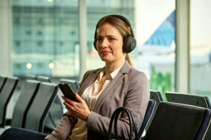 Woman listening to Auracast bluetooth announcments