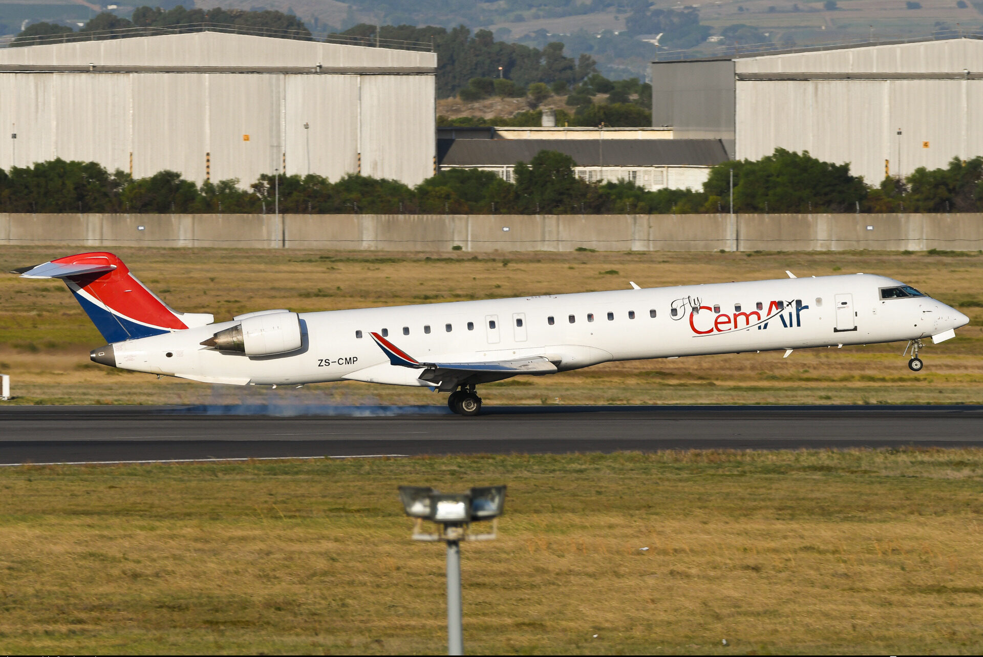 CemAir's Bombardier CRJ-900LR (CL-600-2D24) taking flight off runway.