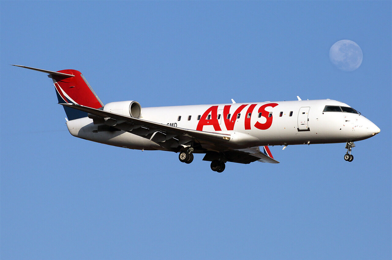 CemAir Bombardier CRJ-100ER in flight in blue skies.