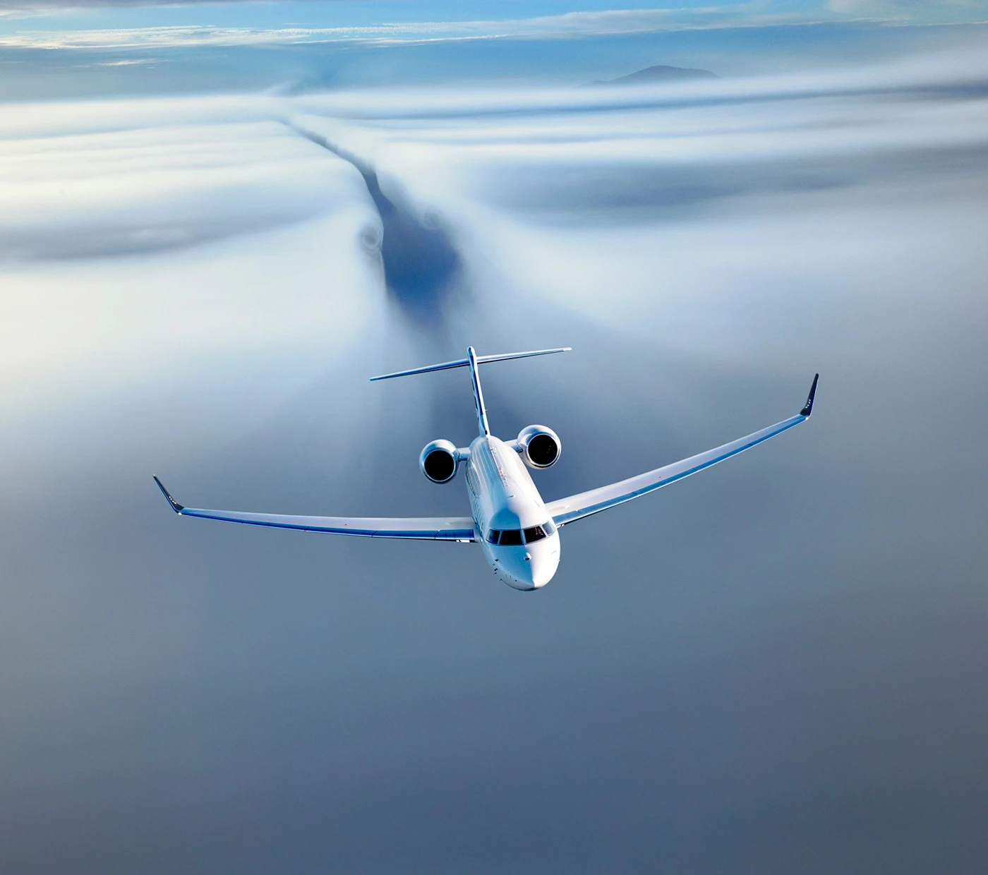 Bombardier Global 8000 ultra-long-range business jet flying above cloud layer
