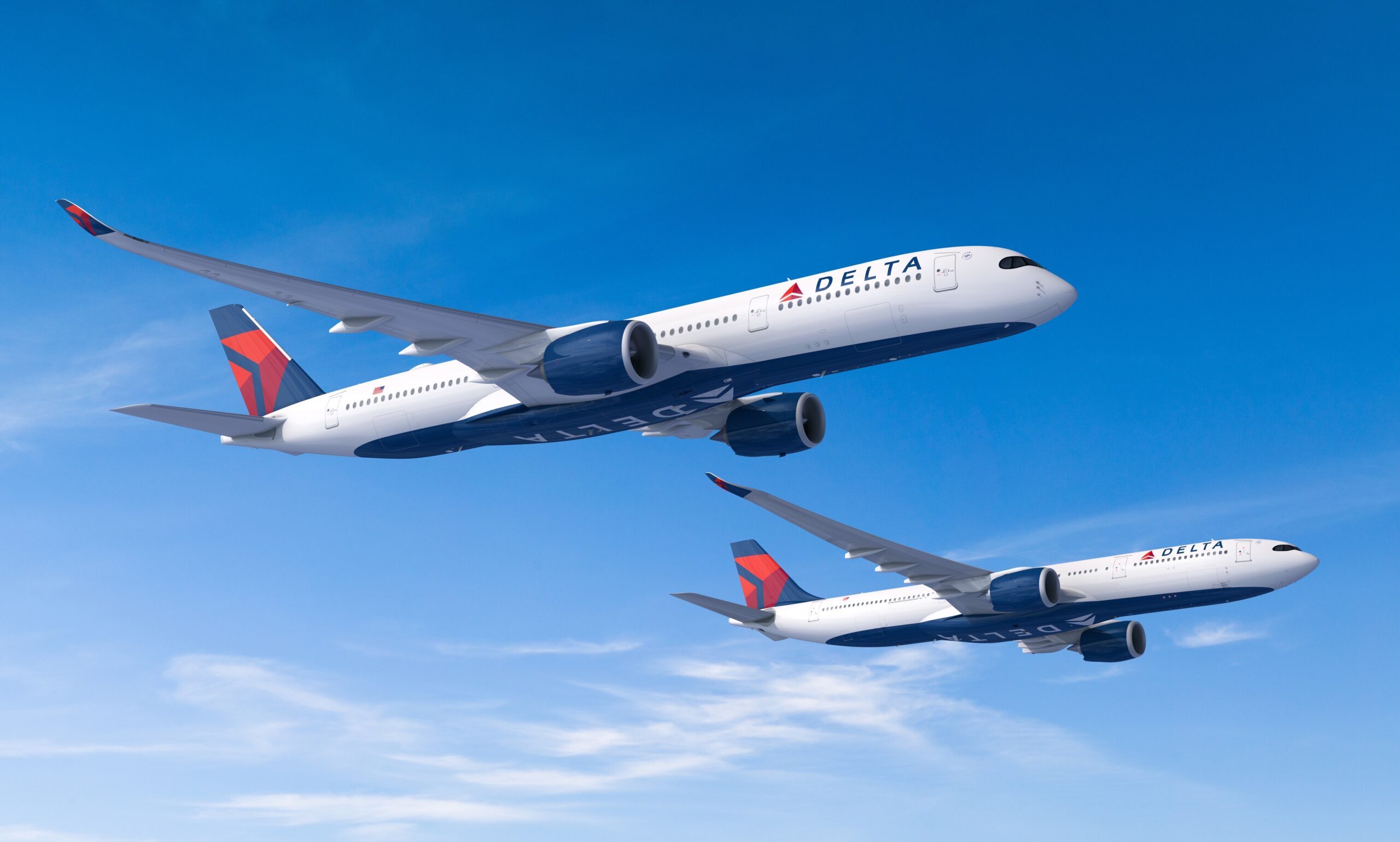 Two Delta Air Lines Airbus aircraft flying in the blue sky.