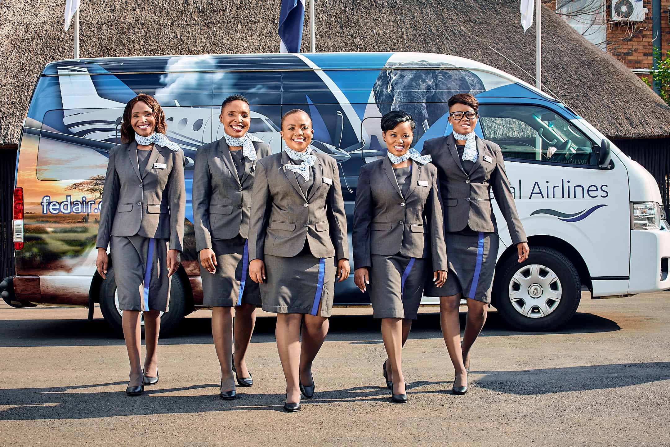 FedAir Staff standing in front of Safari Shuttle