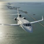 Luxaviation One private jet flying across the ocean.