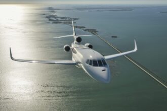 Luxaviation One private jet flying across the ocean.