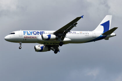 A320 by FlyOne Armenia flies with clouds in the background.