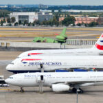 Passenger jetliners are parked on Heathrow Airport's tarmac.
