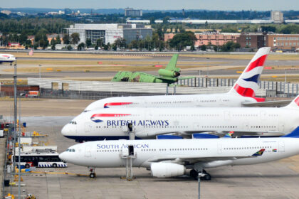Passenger jetliners are parked on Heathrow Airport's tarmac.