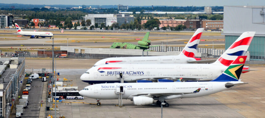 Passenger jetliners are parked on Heathrow Airport's tarmac.
