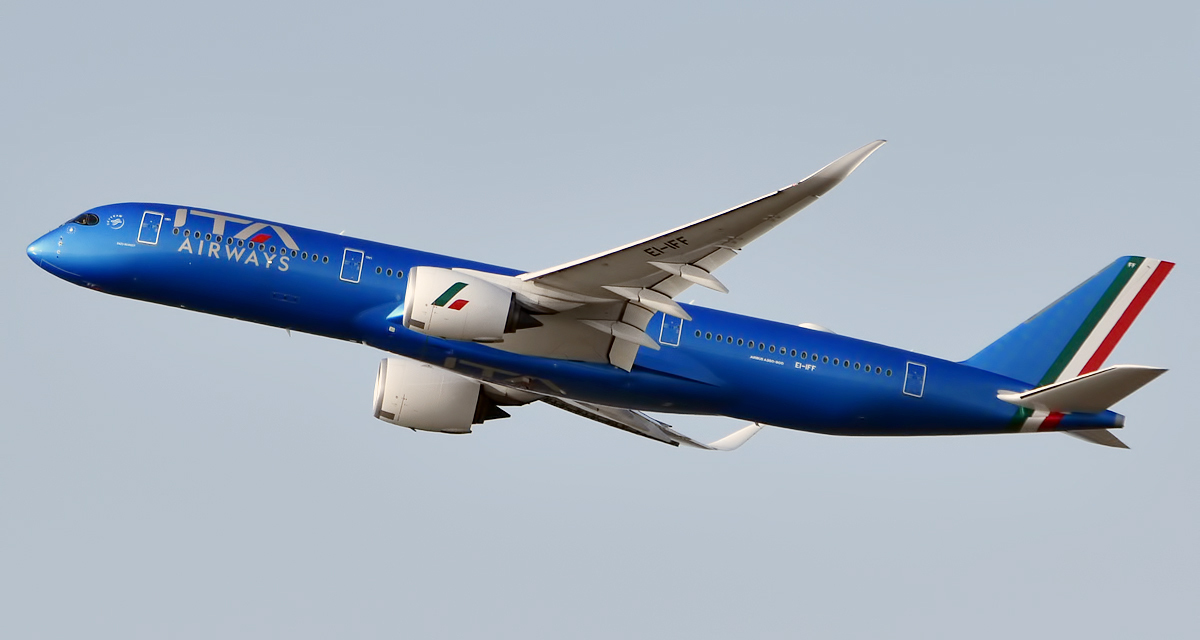 Blue ITA Airways aircraft flying in the sky, towards the left corner.