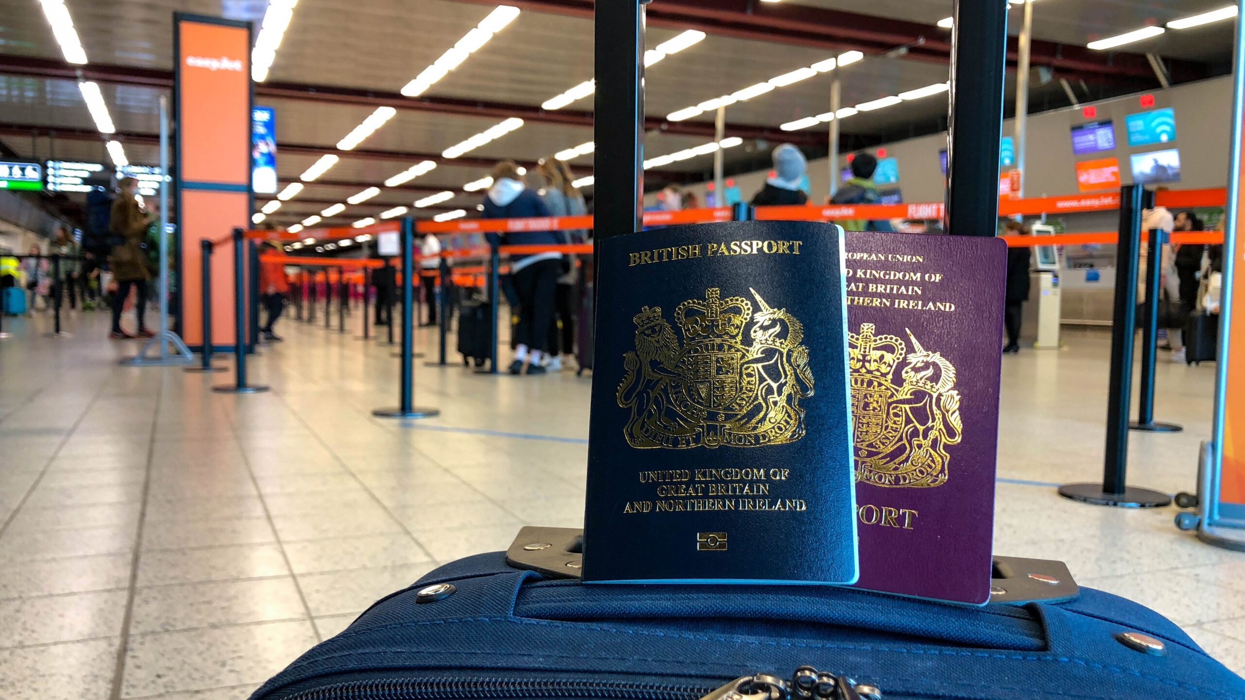 London Luton Airport Summer, passports on a suitcase.