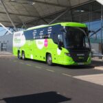 Green Flibco bus in front of the London Stansted Airport