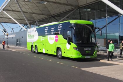 Green Flibco bus in front of the London Stansted Airport