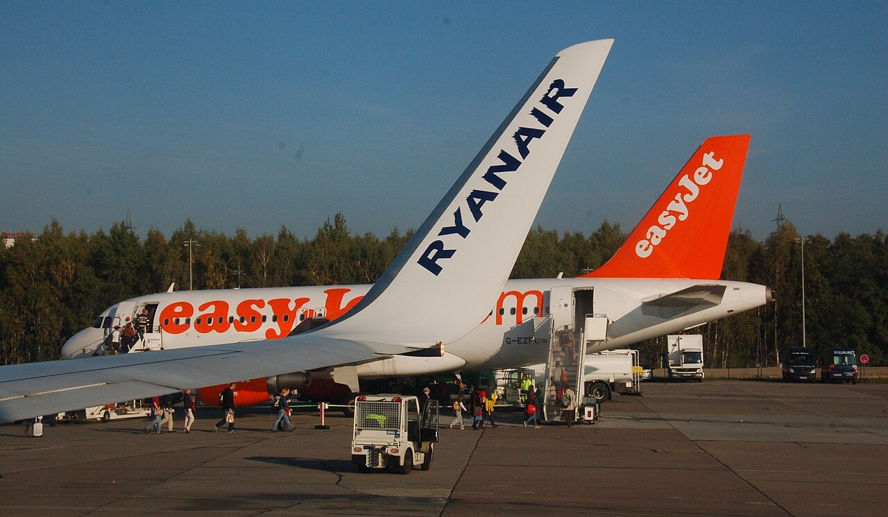 A Ryanair aircraft in front of an easyJet aircraft at Berlin Schönefeld Airport.